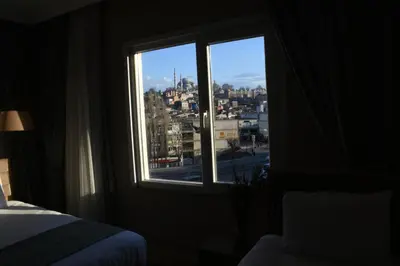 a bedroom with a window with a view of a city at Cibali Hotel Istanbul in Istanbul