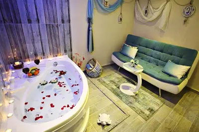 a bathroom with a bath tub and a couch at Balance Hotel Taksim in Istanbul