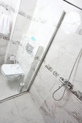 a bathroom with a shower with a toilet and a sink at Balance Hotel Taksim in Istanbul