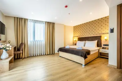 a hotel room with a bed and a desk at Emin Palace in Istanbul