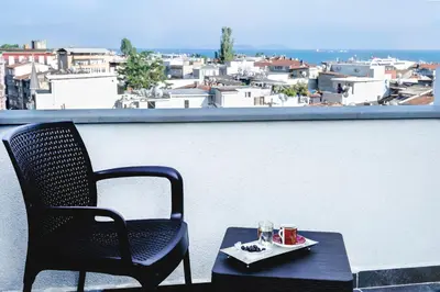 a table and a chair on a balcony with a view at Emin Palace in Istanbul