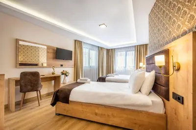 a hotel room with two beds and a desk at Emin Palace in Istanbul