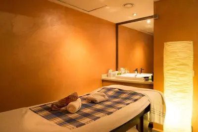a bathroom with a bed with a sink and a mirror at Felicity Hotel İstanbul in Istanbul