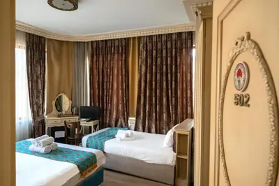 a hotel room with two beds and a mirror at Felicity Hotel İstanbul in Istanbul
