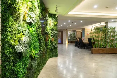 a lobby with a green wall with plants at Felicity Hotel İstanbul in Istanbul