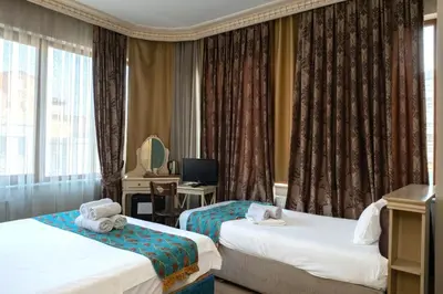 a hotel room with two beds and a television at Felicity Hotel İstanbul in Istanbul