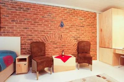 two chairs and a table in front of a brick wall at Newly renovated apartment-studio in Istanbul