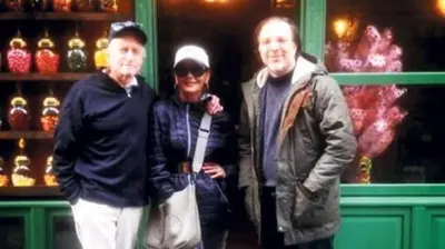two men and a woman standing in front of a store at Newly renovated apartment-studio in Istanbul