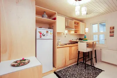a kitchen with a white refrigerator and a table at Newly renovated apartment-studio in Istanbul