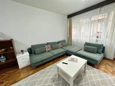 a living room with a green couch and a table at Taksim Cihangir'de 2+1 daire in Istanbul