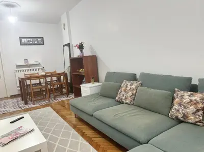 a living room with a green couch and a table at Taksim Cihangir'de 2+1 daire in Istanbul