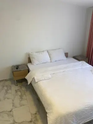 a bedroom with a white bed and a side table at YENİKAPI hotel in Istanbul