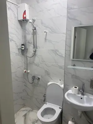 a white bathroom with a toilet and a sink at YENİKAPI hotel in Istanbul