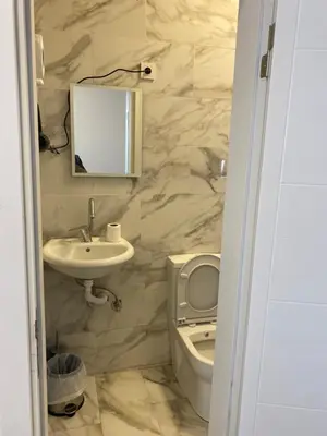 a bathroom with a sink and a toilet and a mirror at YENİKAPI hotel in Istanbul