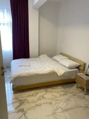 a bed in a bedroom with a marble floor at YeniKAPI in Istanbul