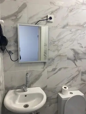 a bathroom with a sink and a mirror and a toilet at YeniKAPI in Istanbul