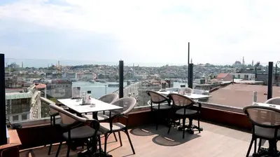 a restaurant with tables and chairs on a balcony at Karakoy Aparts Hotel - Special Category in Istanbul