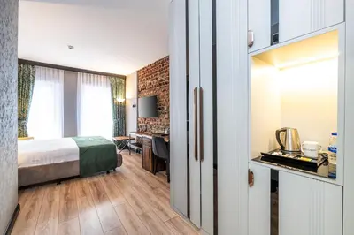 a hotel room with a bed and a desk at Karakoy Aparts Hotel - Special Category in Istanbul