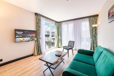 a living room with a green couch and a table at Karakoy Aparts Hotel - Special Category in Istanbul
