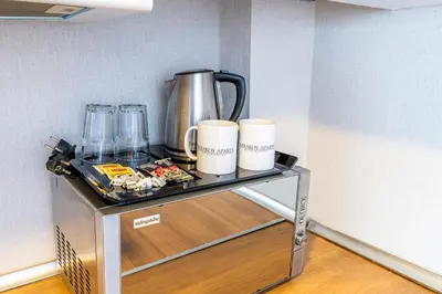 a table with a blender and cups on it at Karakoy Aparts Hotel - Special Category in Istanbul