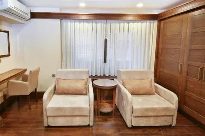 a living room with two chairs and a table at Kumluk Konak Hotel in Istanbul