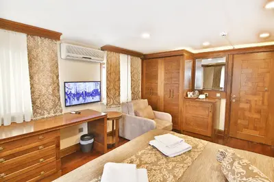 a living room with a desk and a tv at Kumluk Konak Hotel in Istanbul