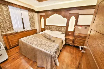 a bedroom with a bed and a dresser in it at Kumluk Konak Hotel in Istanbul