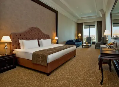 a hotel room with a large bed and a piano at Vialand Palace Hotel in Istanbul