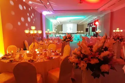 a banquet hall with white tables and chairs and flowers at Vialand Palace Hotel in Istanbul