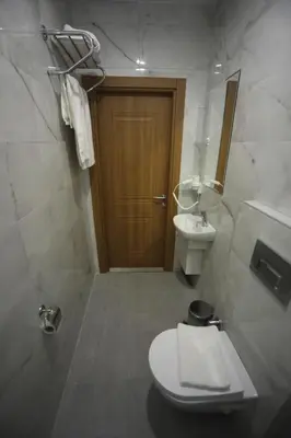 a bathroom with a toilet and a sink at Yuvam Vari Hotel in Istanbul