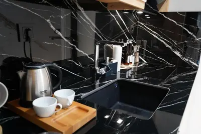 a kitchen counter with two cups on a cutting board at Adgsuites in Istanbul