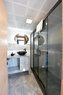 a bathroom with a glass shower and a sink at Sunlife Oldcity in Istanbul