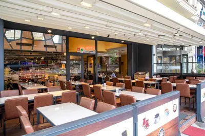 a restaurant with tables and chairs in a building at Grand Aras Hotel & Suites in Istanbul