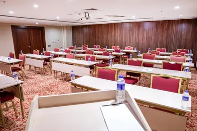 an empty classroom with tables and chairs and water bottles at Grand Aras Hotel & Suites in Istanbul