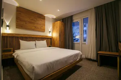 a bedroom with a large bed and a window at Kaya Hotel SAW in Istanbul