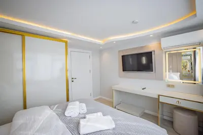 a bedroom with a bed with a desk and a tv at ISTANBUL SUITE in Istanbul