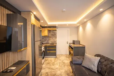 a living room with a couch and a kitchen at ISTANBUL SUITE in Istanbul