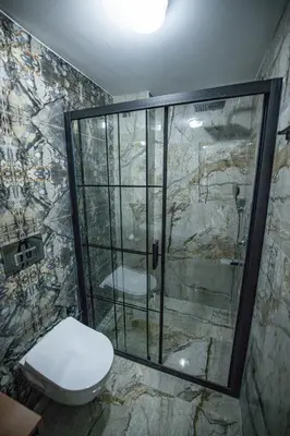 a bathroom with a toilet and a glass shower at ISTANBUL SUITE in Istanbul