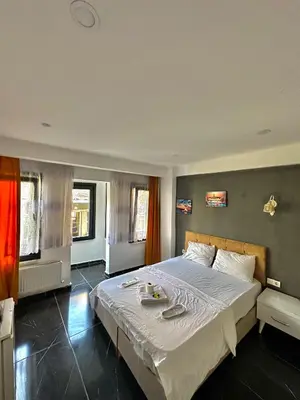a bedroom with a large bed with white sheets at happy apart hotel istanbul in Istanbul