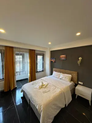 a bedroom with a large bed with towels on it at happy apart hotel istanbul in Istanbul