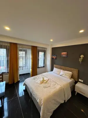 a bedroom with a large bed with a white blanket at happy apart hotel istanbul in Istanbul