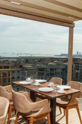 a table on a balcony with a view of a city at Istanbul Old City Beyazid Belmond Hotel in Istanbul