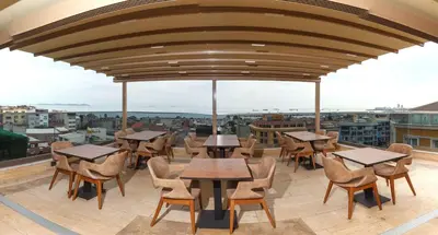 a restaurant with tables and chairs on a roof at Istanbul Old City Beyazid Belmond Hotel in Istanbul