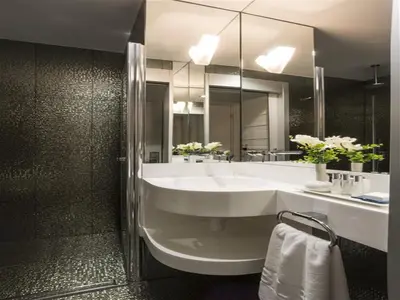 a bathroom with a sink and a large mirror at Bilek Hotel Kavacık in Istanbul