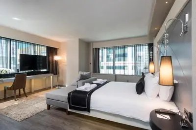 a bedroom with a large bed and a large window at Bilek Hotel Kavacık in Istanbul