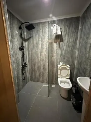 a bathroom with a shower and a toilet and a sink at Emsa Otel Maltepedeki Eviniz in Istanbul