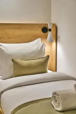a bedroom with a bed with white pillows and a lamp at Joyway Hotels Istanbul Sultanahmet in Istanbul