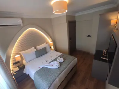 a bedroom with a large bed with a stuffed animal on it at Mara Oldcity Hotel in Istanbul