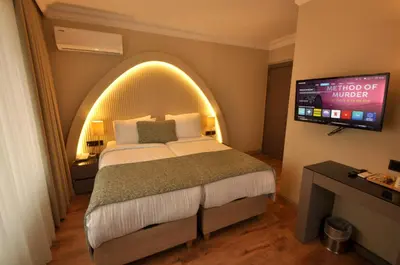 a hotel room with a bed and a tv at Mara Oldcity Hotel in Istanbul