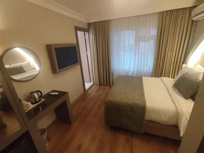 a hotel room with a bed and a mirror at Mara Oldcity Hotel in Istanbul